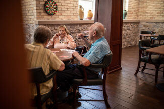 A group of people playing cards.