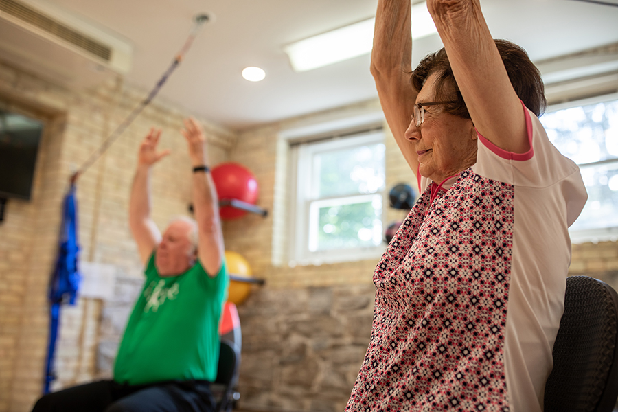 Two seniors stretching