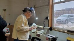 A woman using a lathe machine