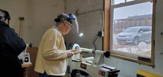 A woman using a lathe machine